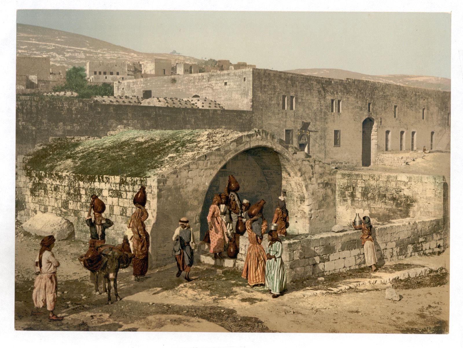 Women with water jars at the spring of Nazareth, known as the Virgin's Fountain (Mary's Well), c. 1890–1900.